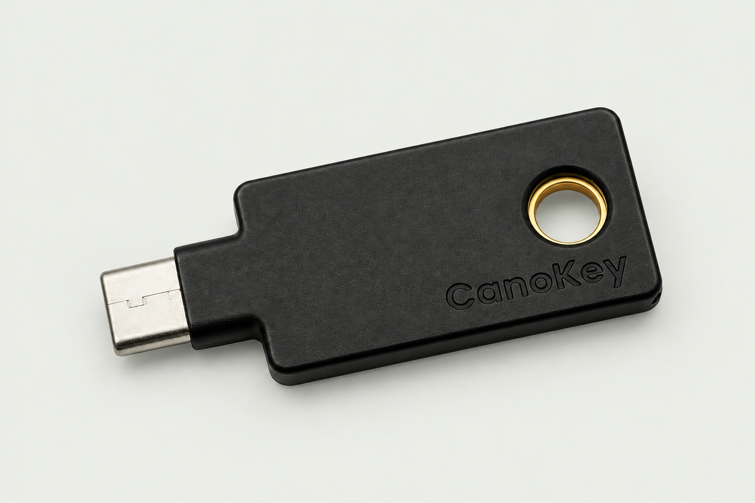 CanoKey security key, with its engraved CanoKey logo, USB-C connector and gold keyring detail